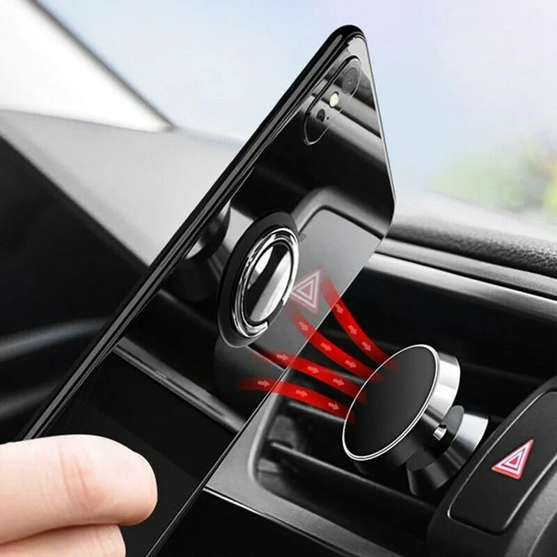 Black magnetic car phone mount attaching to a vehicle air vent, with a circular ring holder on the back of a phone.