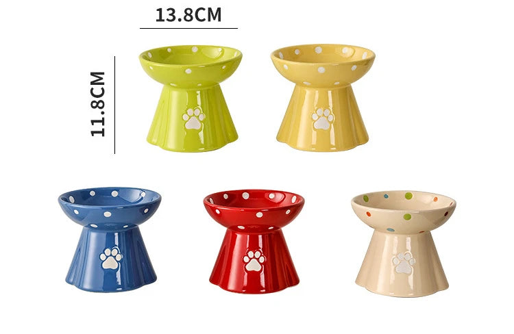 Five colourful, elevated ceramic cat bowls featuring polka dot patterns and a white paw print design.