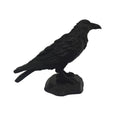 Matte black raven bird figurine perched on a stone-effect base, featuring detailed 3D-printed texture.