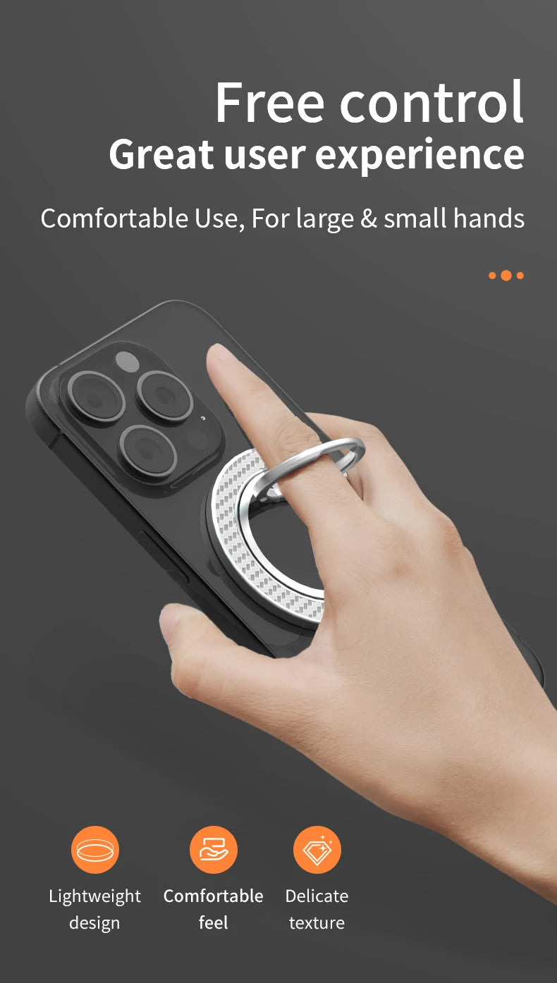 Silver circular smartphone ring holder with textured rim attached to the back of a black phone, held by a hand.