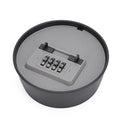 Grey and black round plastic key lock box with a four-digit combination dial and top release tab.