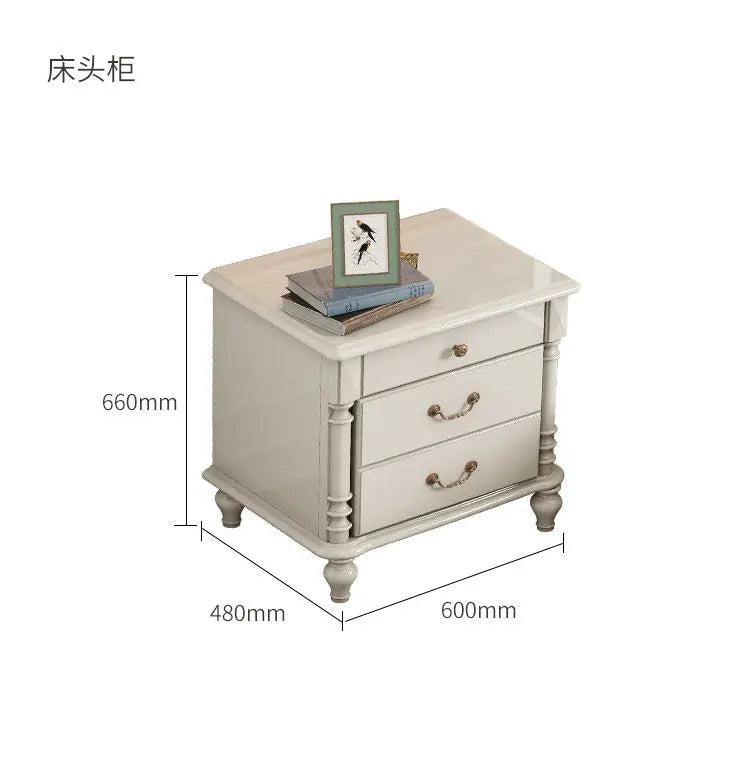 Elegant cream-coloured bedside table with three drawers, ornate legs and vintage-style brass handles.