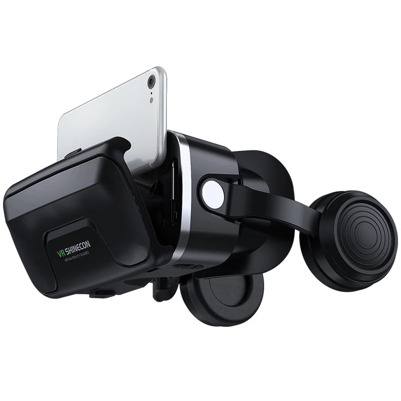 Black virtual reality headset with adjustable head strap and integrated headphones, shown holding a silver smartphone.