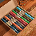 Gift box containing ten assorted colourful tubes of incense sticks with traditional oriental design labels.