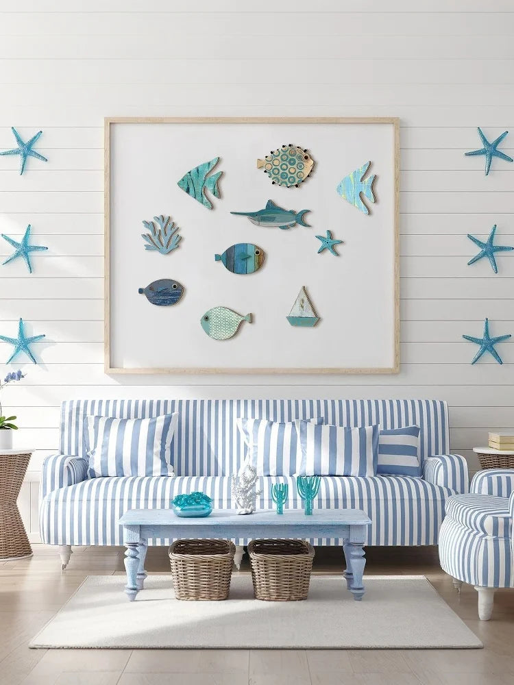 Set of 10 coastal-style wooden wall decorations featuring blue and teal fish, starfish, and a small sailboat.