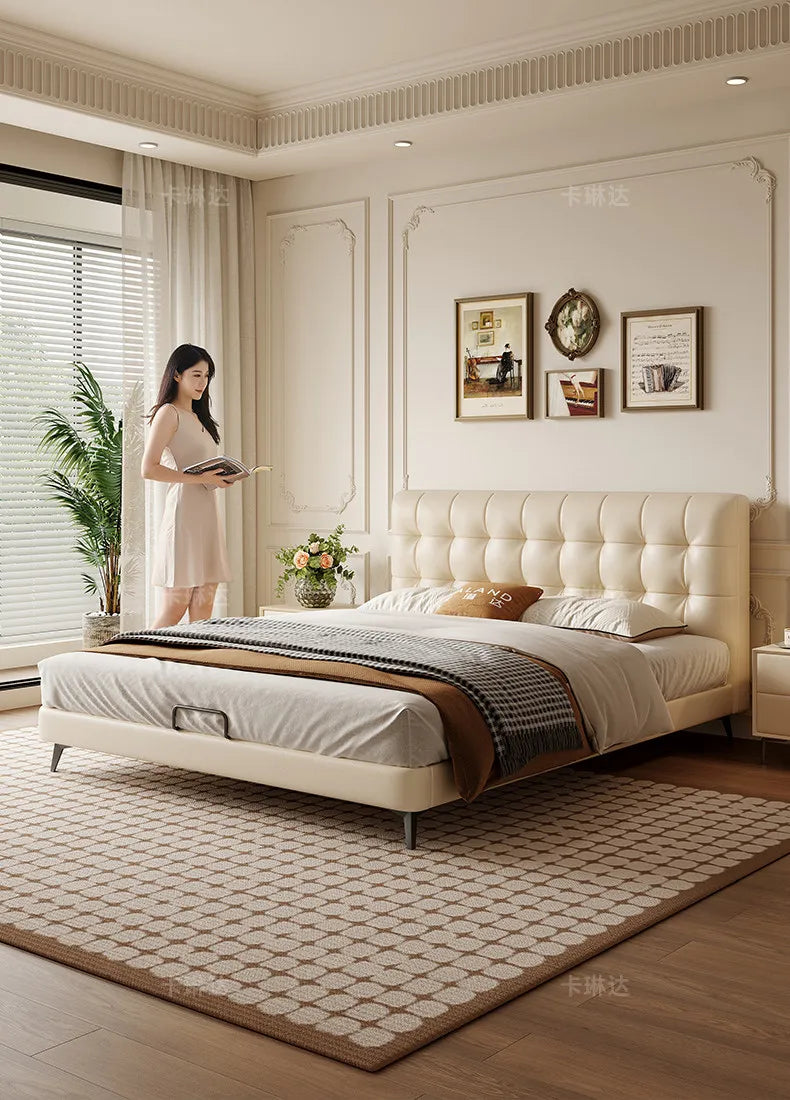Minimalist cream ottoman storage bed with a tufted headboard and sleek metal legs in a contemporary bedroom setting.