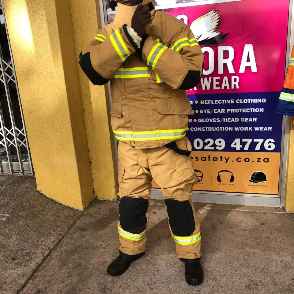 Tan heavy-duty firefighter jacket and trousers with yellow reflective strips and black reinforced knee and elbow patches.