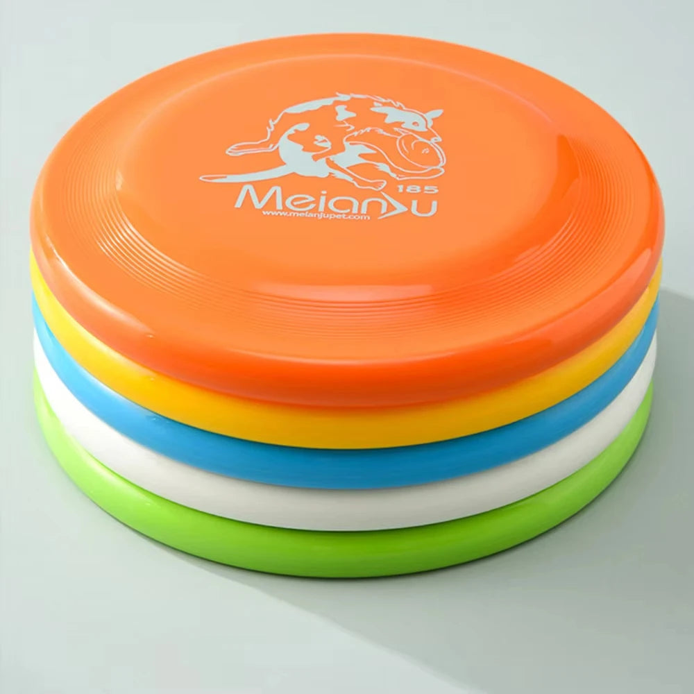A stack of five durable plastic dog flying discs in orange, yellow, blue, white, and lime green.