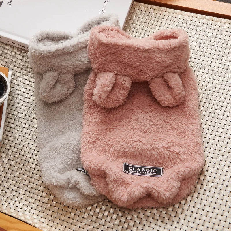 Pink and grey fleece dog hoodies with bear ears and a "Classic" patch.