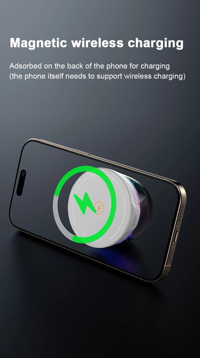 A small white, round portable speaker magnetically attached to the back of a smartphone for wireless charging.