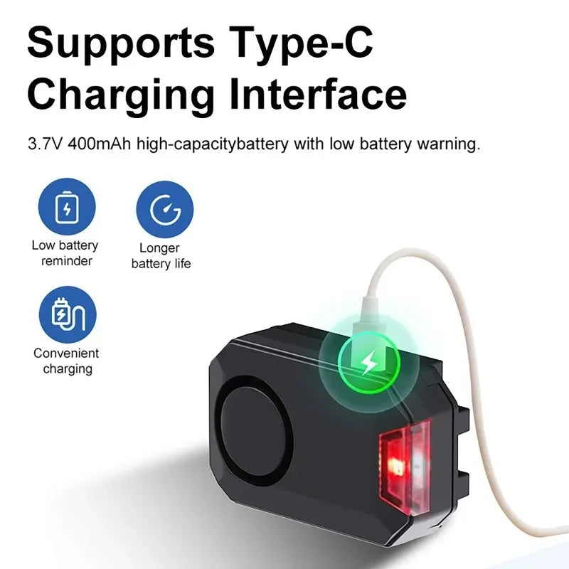 Black plastic rechargeable bike alarm with a USB-C port, red indicator light, and 400mAh battery.