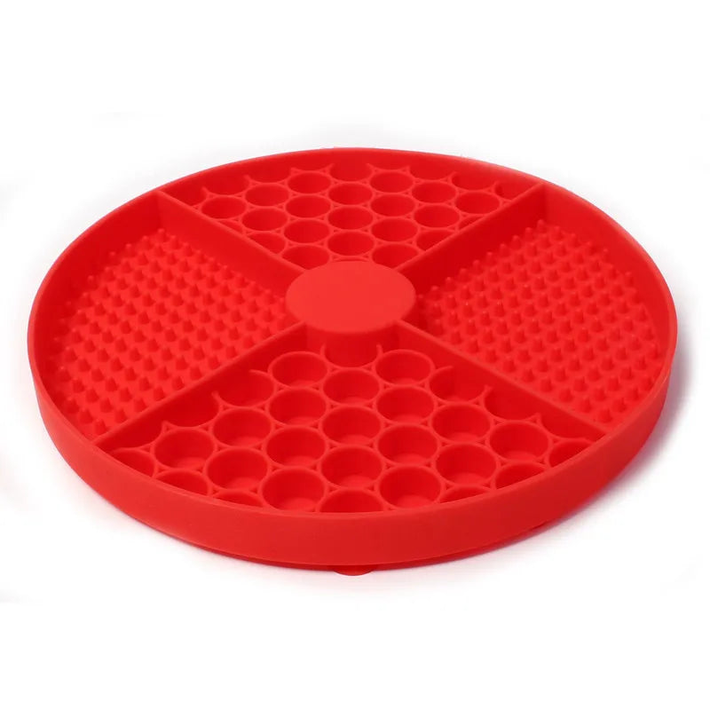 Red round silicone pet slow feeder mat with four quadrants featuring textured patterns and circular indentations.