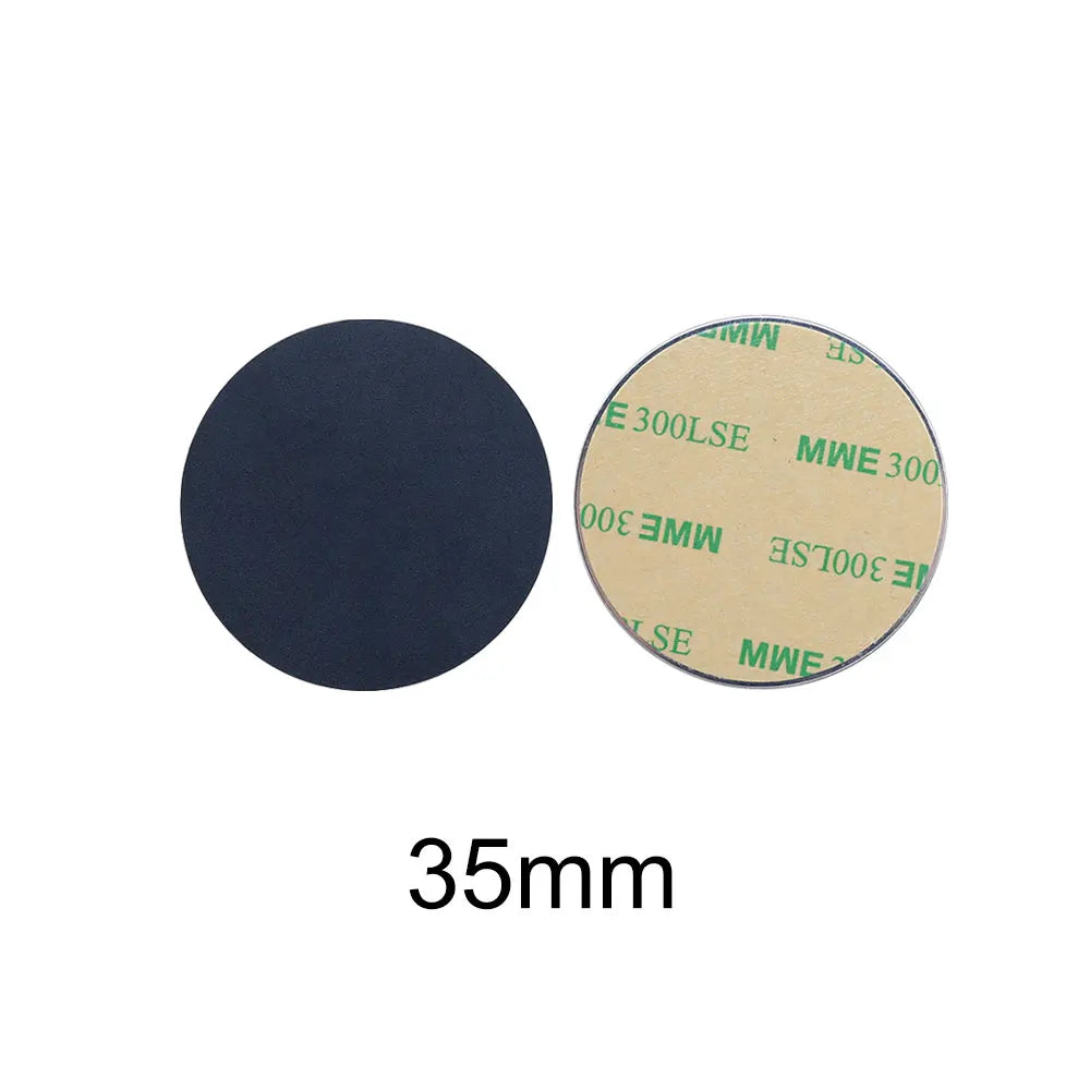 Two 35mm adhesive-backed circular discs: one shows a smooth black front, the other a beige peel-off adhesive side.