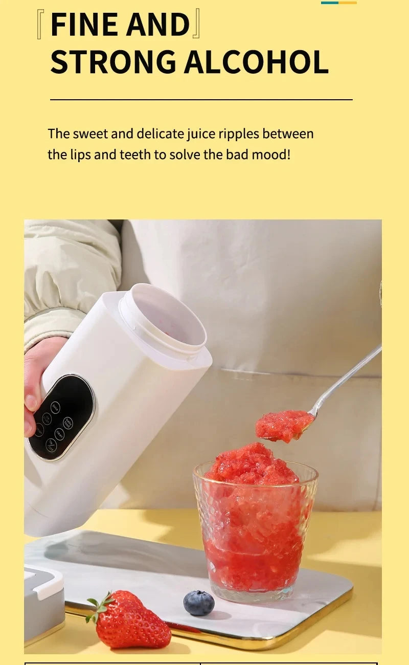 A white, modern handheld blender pouring a red, icy smoothie into a glass, next to a strawberry and blueberry.