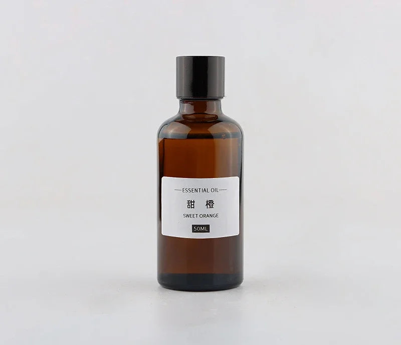 Amber glass bottle of Sweet Orange essential oil with a black cap, 50ml size, on a white background.