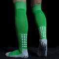 Bright green, knee-high sports socks with ribbed cuffs, white grid detailing, and grey grip soles.
