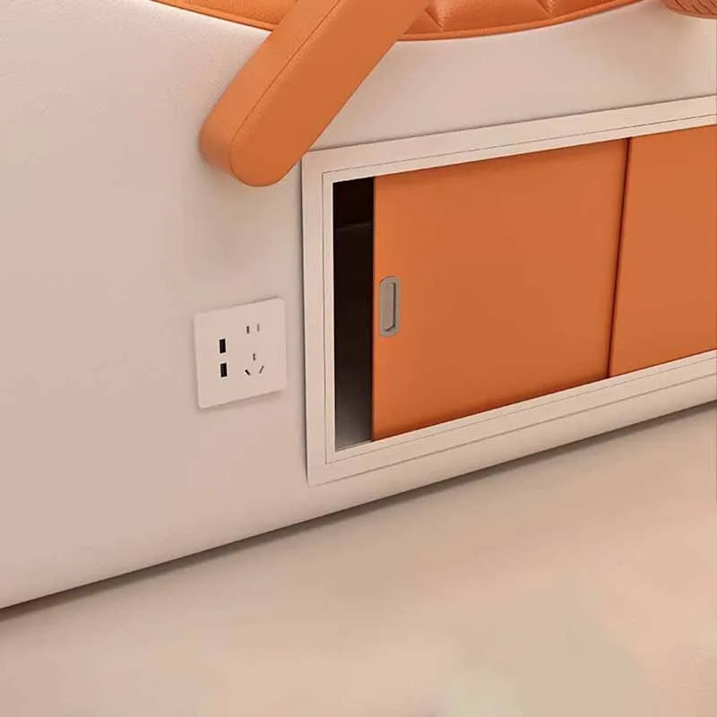 White and orange professional massage bed featuring a convenient sliding storage compartment and built-in power socket.