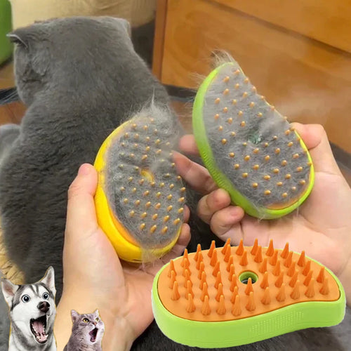 Hands holding a yellow and green steamy pet brush with silicone bristles, shown collecting loose fur from a grey cat.