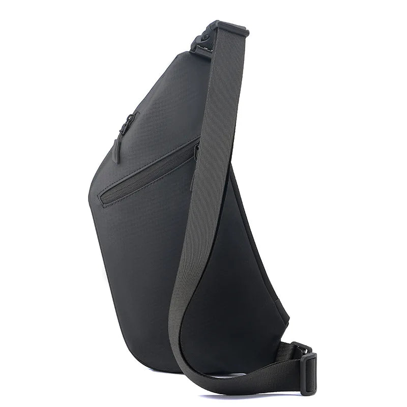 Side view of a slim black men's anti-theft crossbody sling bag with a comfortable adjustable strap and zip pockets.