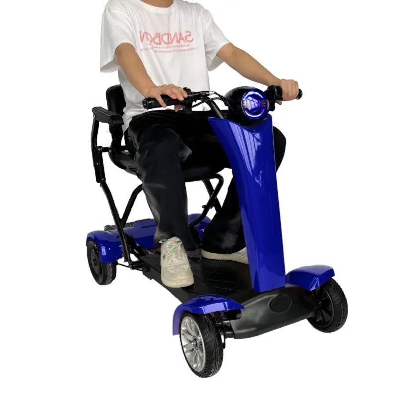 Blue 4-wheel electric mobility scooter with a black padded seat, handlebars, and a round front headlight.