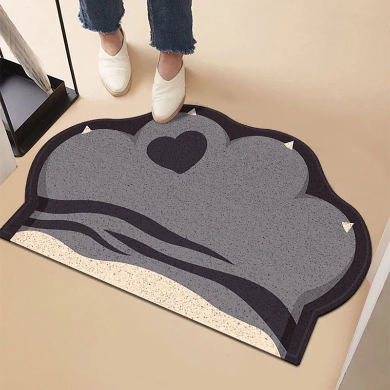 Grey, paw-shaped anti-slip cat litter mat with a cute heart detail and textured surface for trapping litter.