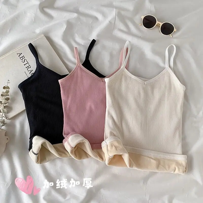 Three thermal camisole tops in black, pink, and white, featuring a ribbed design and soft, fleece-lined interior.