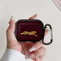 Black silicone AirPods Pro case featuring a running cheetah design and a matching black carabiner clip.