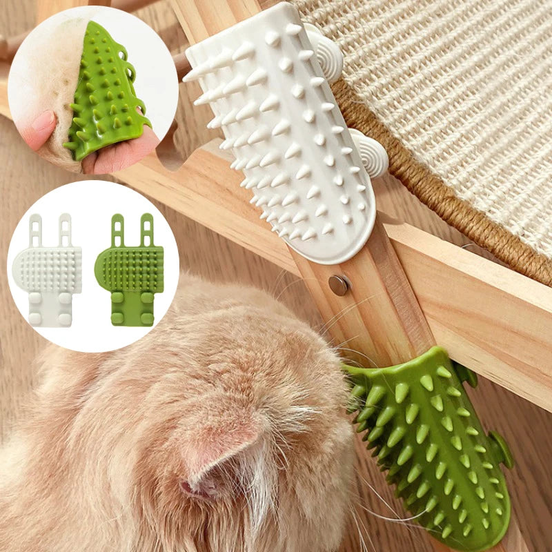 Green and white rubber cat self-grooming brushes attached to a wooden furniture corner, rubbing against a ginger cat.