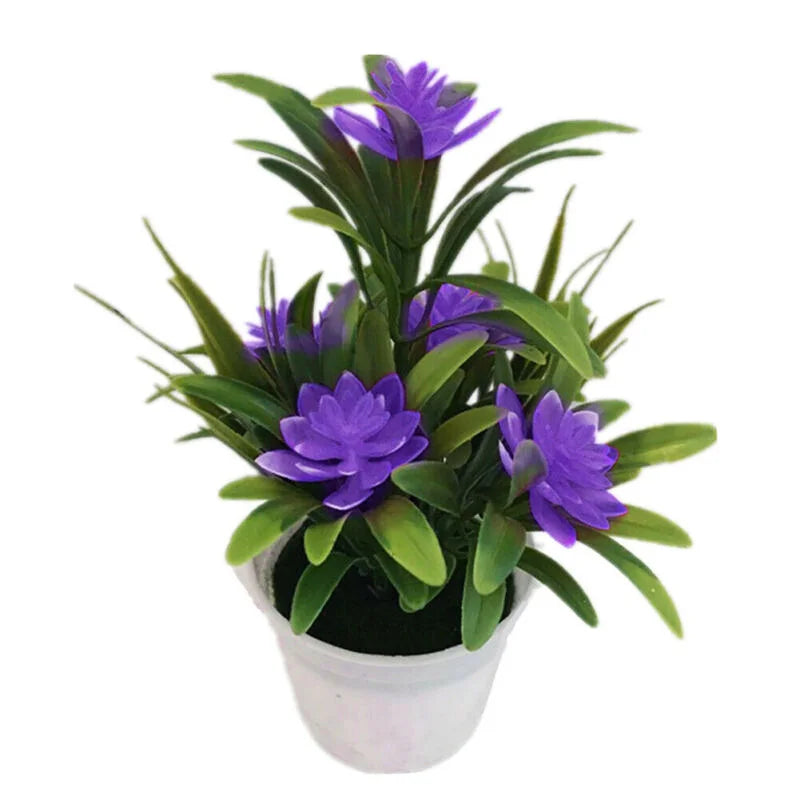Artificial purple lotus-style flowers with green leaves in a small white plastic pot on a white background.