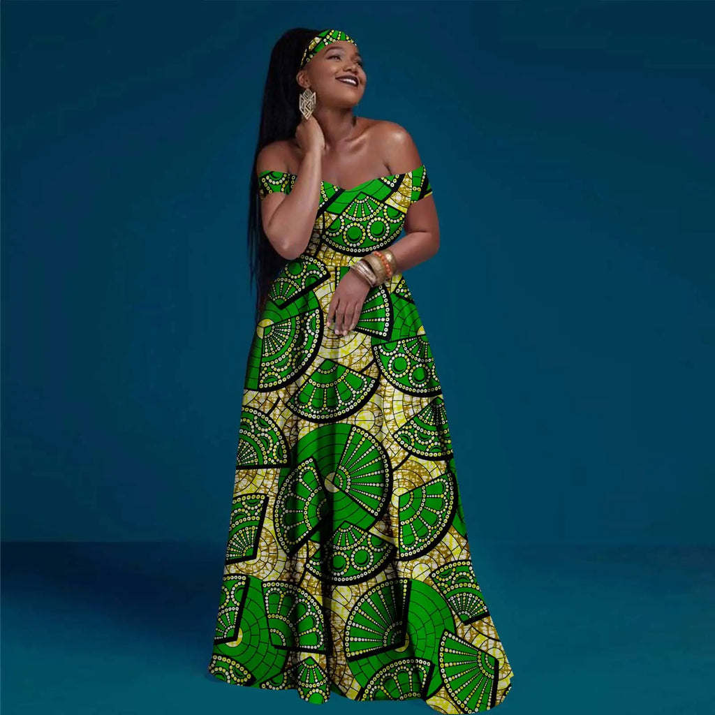 Woman wearing an off-shoulder, floor-length maxi dress in green and yellow with a fan pattern and matching headband.