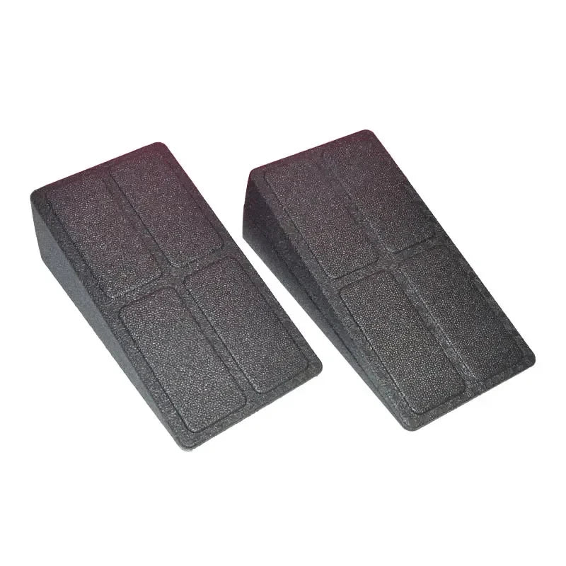 Two black, wedge-shaped door stops made of textured, heavy-duty plastic with a rectangular four-panel grid design.