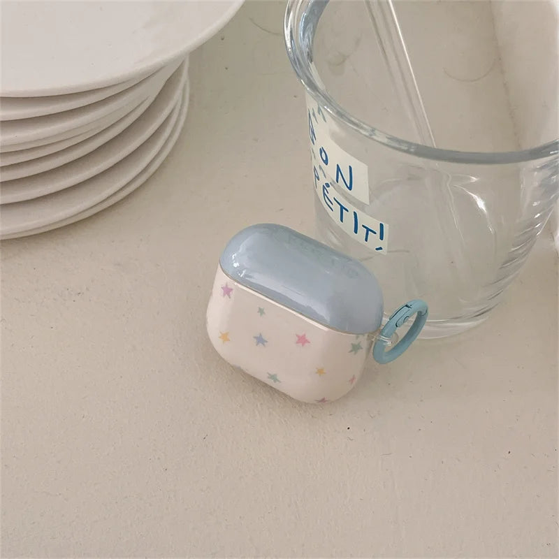 Blue and white star-print hard shell case for AirPods Pro, featuring an integrated matching carabiner clip.