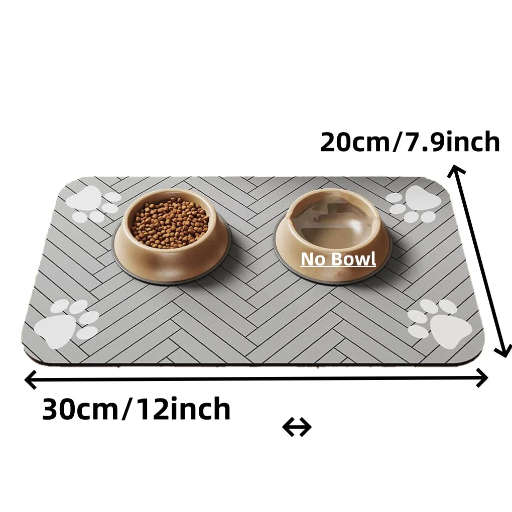 Grey pet feeding mat with herringbone pattern and paw prints, featuring one bowl filled with food and one empty.