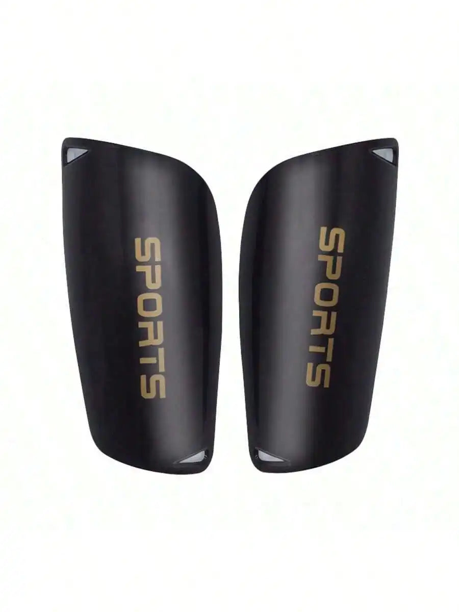 Pair of black football shin guards with gold "SPORTS" text, featuring a sleek, protective ergonomic design.