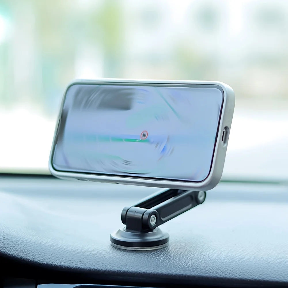 Adjustable black magnetic phone mount attached to a car dashboard, holding a smartphone in landscape orientation.