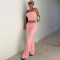 Pastel pink two-piece set featuring a strapless bandeau crop top and high-waisted, flared trousers.