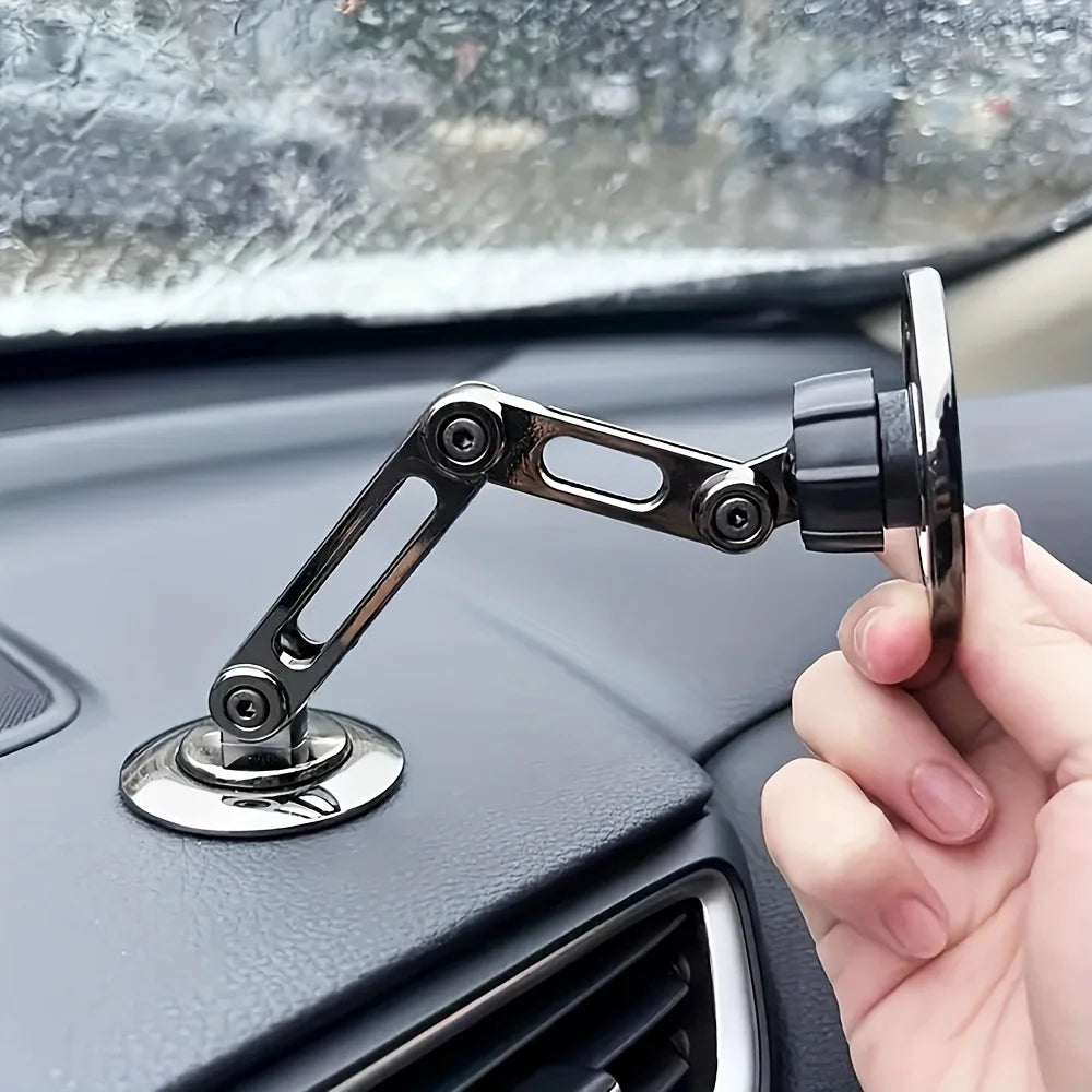Adjustable metallic grey car phone mount with a multi-hinge foldable arm, attached to a dashboard base.