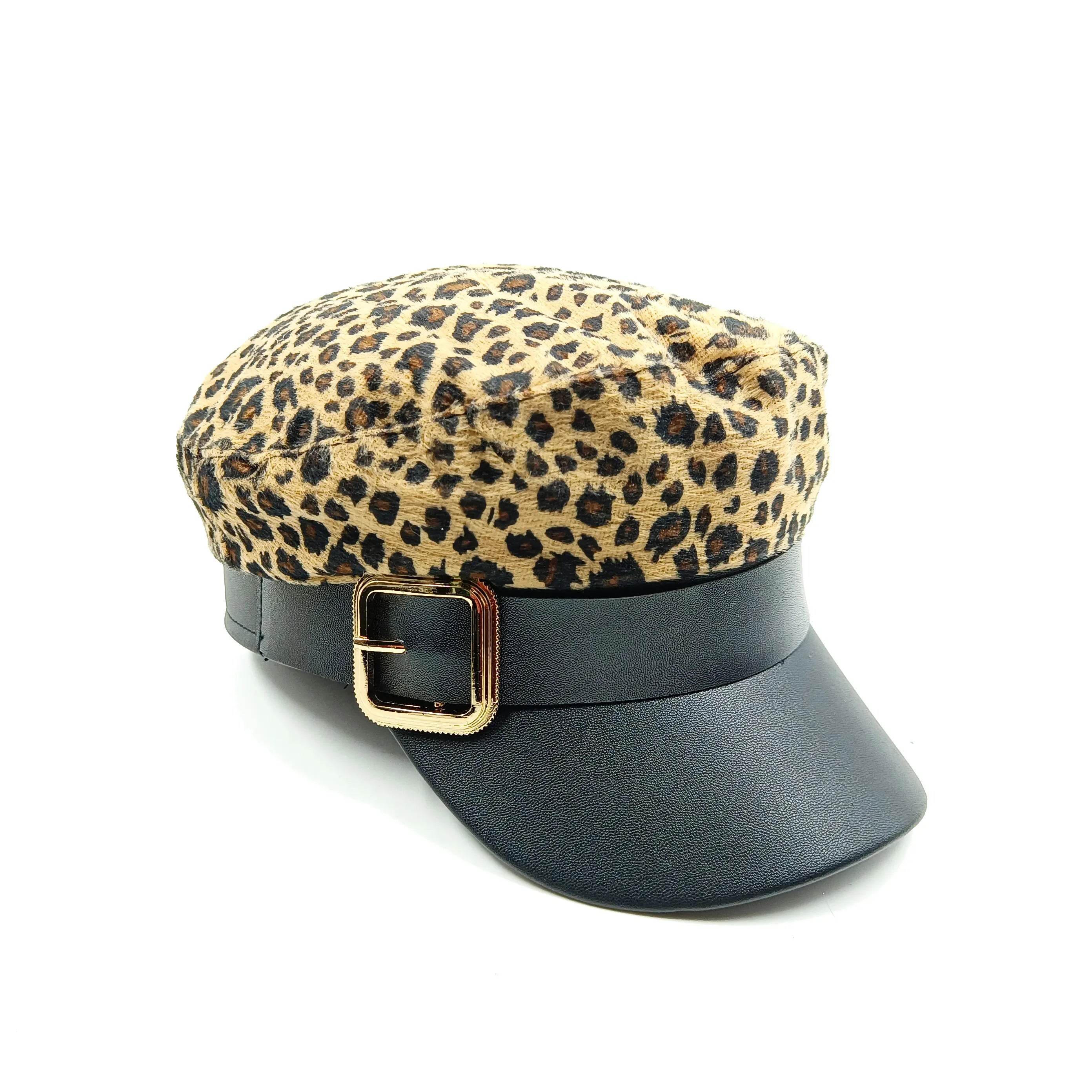 Leopard print baker boy cap with a black faux leather trim, peak and decorative gold-tone buckle detail.