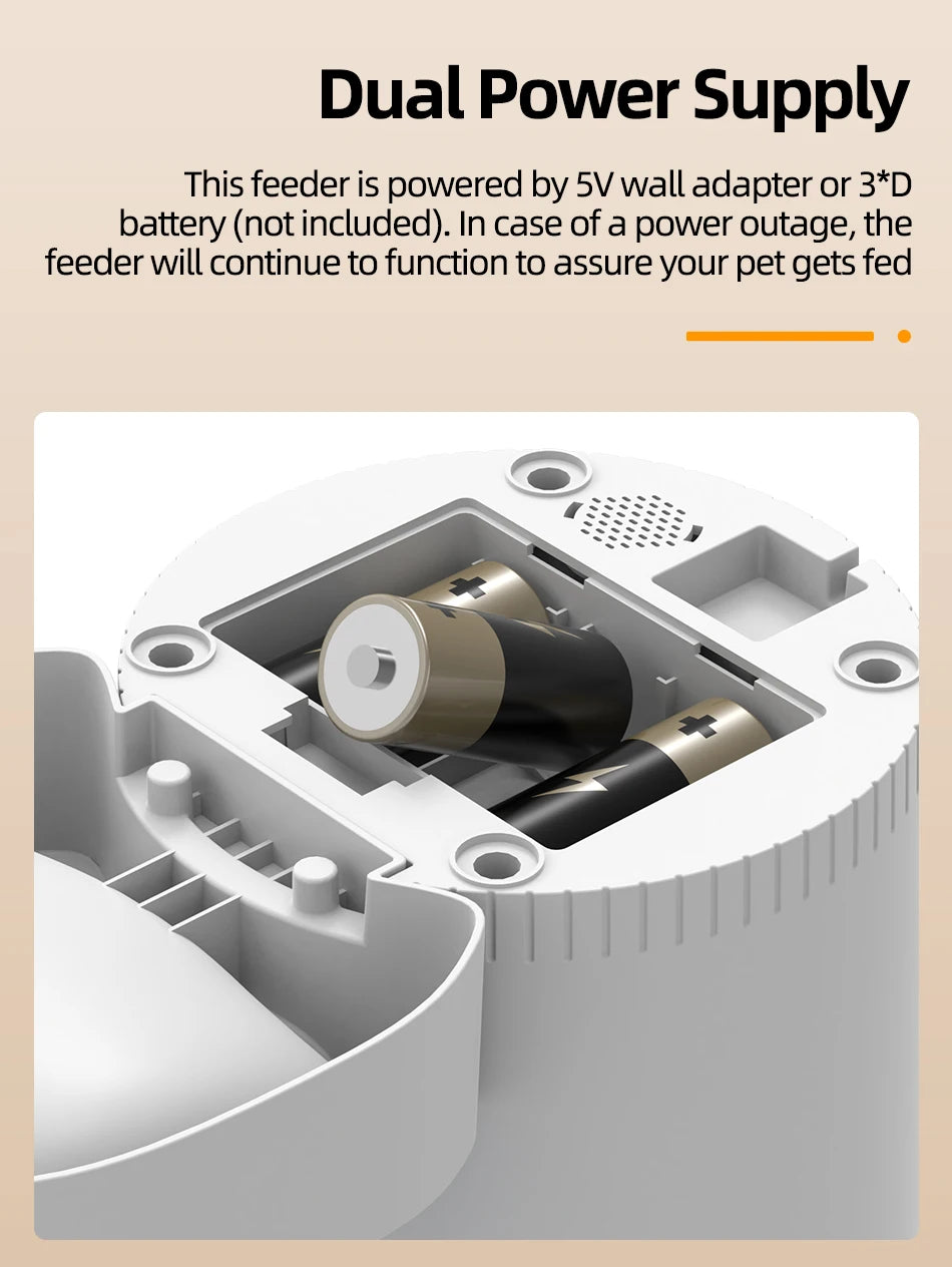 White plastic pet feeder base with open battery compartment containing two D-size batteries.