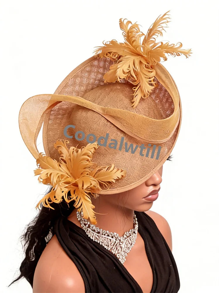 Elegant tan fascinator hat featuring layered fabric, sculptural curves, and decorative feather accents.