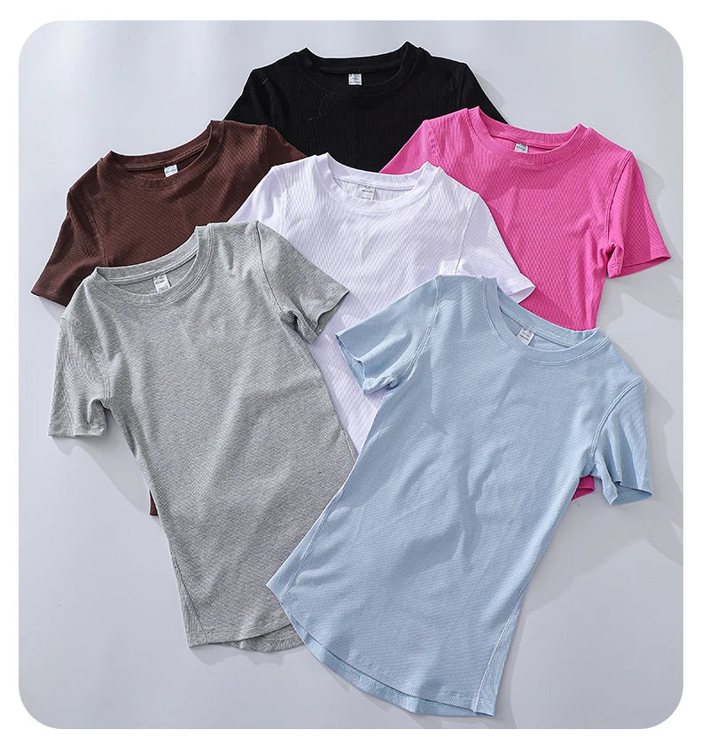 Collection of six short-sleeved, crew neck, ribbed t-shirts in various solid colours on a white background.