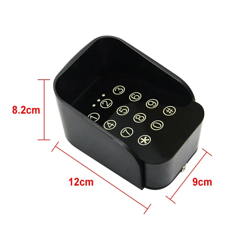 Black plastic protective cover for a numeric keypad, measuring 12cm by 9cm by 8.2cm.