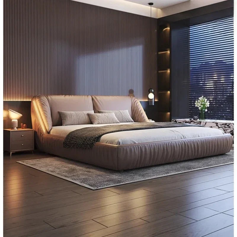 Modern king-size upholstered bed frame in taupe, featuring a curved, cushioned headboard and sleek, low-profile design.