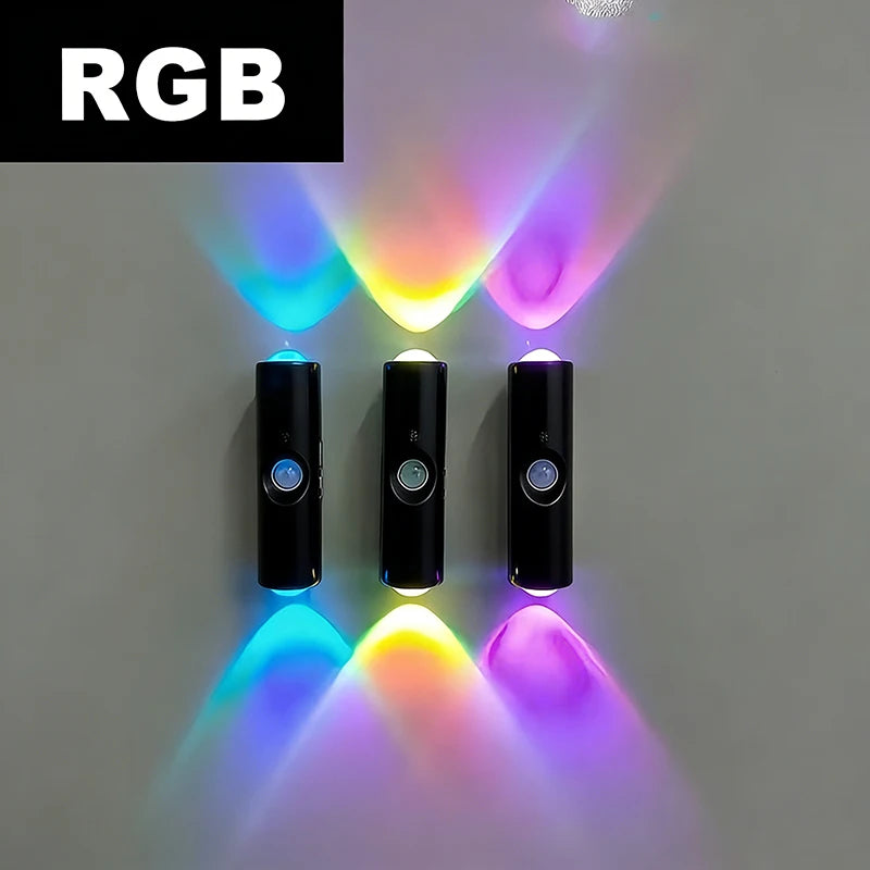 Three slim, black, rechargeable LED wall lights with motion sensors, casting vibrant blue, yellow, and purple light.