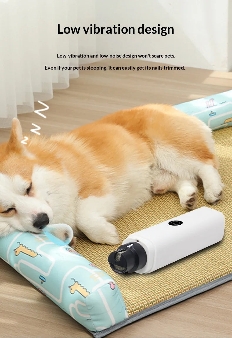 A white, quiet electric pet nail grinder placed on a mat next to a sleeping dog.