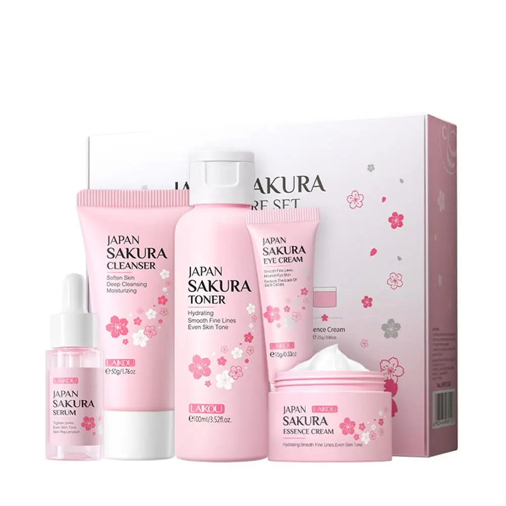 Five-piece pink sakura-themed skincare set, including cleanser, toner, serum, eye cream, and face cream in a gift box.