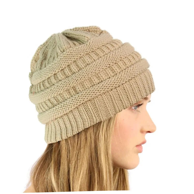 Side profile of a woman wearing a beige ribbed-knit winter beanie with a soft, satin-lined interior.