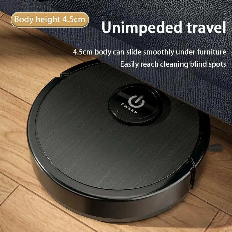 A low-profile black robotic vacuum cleaner sliding smoothly underneath a blue fabric couch on a wooden floor.