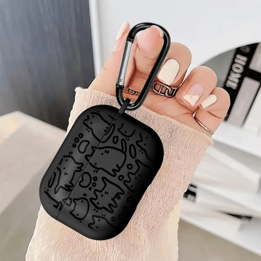 Black silicone AirPods Pro case with doodle cat print and black carabiner held in hand.
