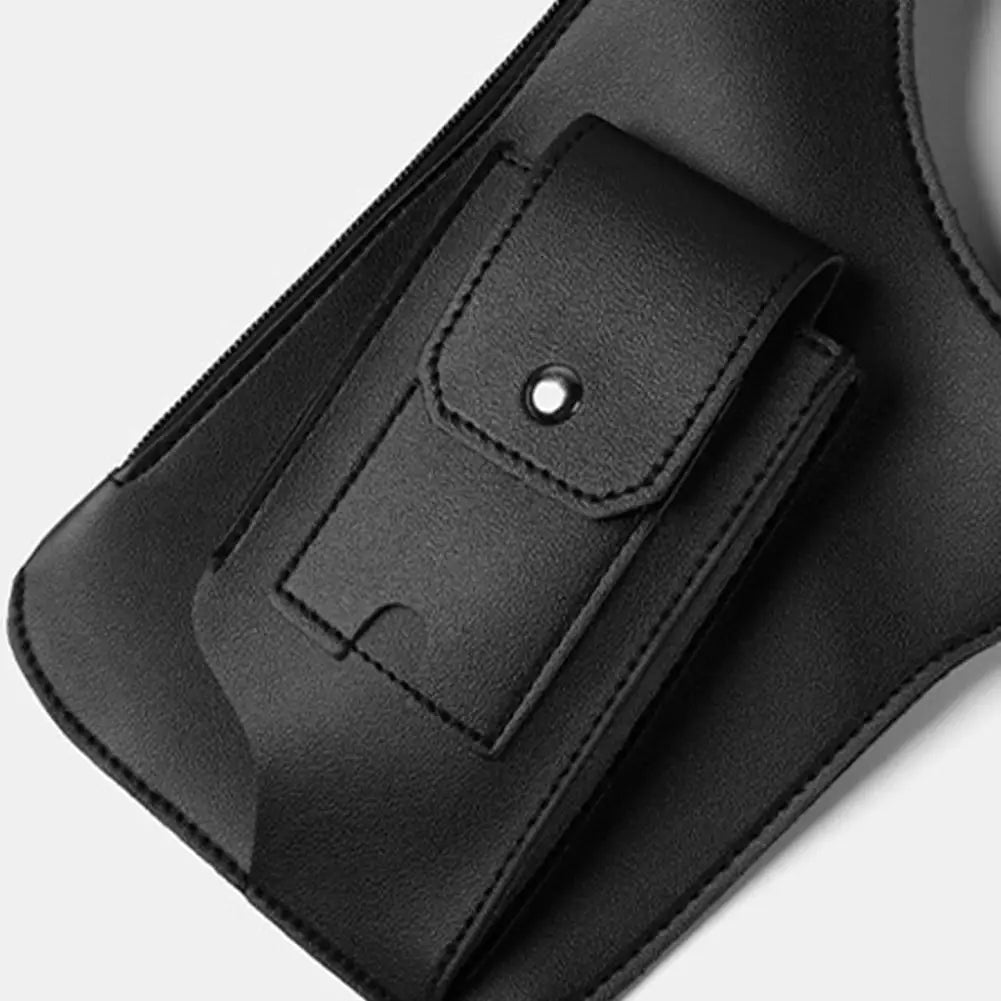 Close-up of a black, faux-leather tactical crossbody bag featuring a snap-button pocket and a secure zip fastening.